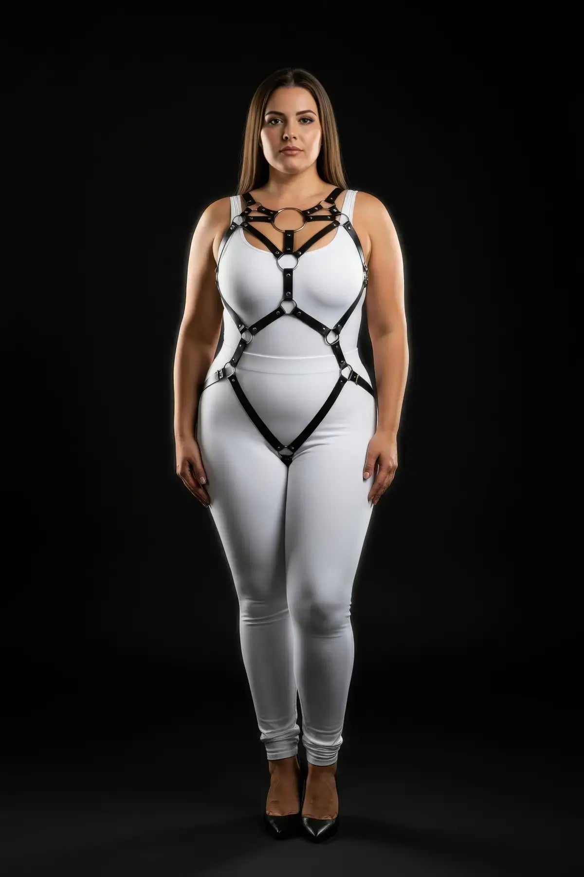 Plus-size black O-ring full-body harness in vegan leather worn over a white bodysuit, HarnessClub.