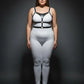 Plus-size black vegan-leather chest and waist harness by HarnessClub worn over white outfit