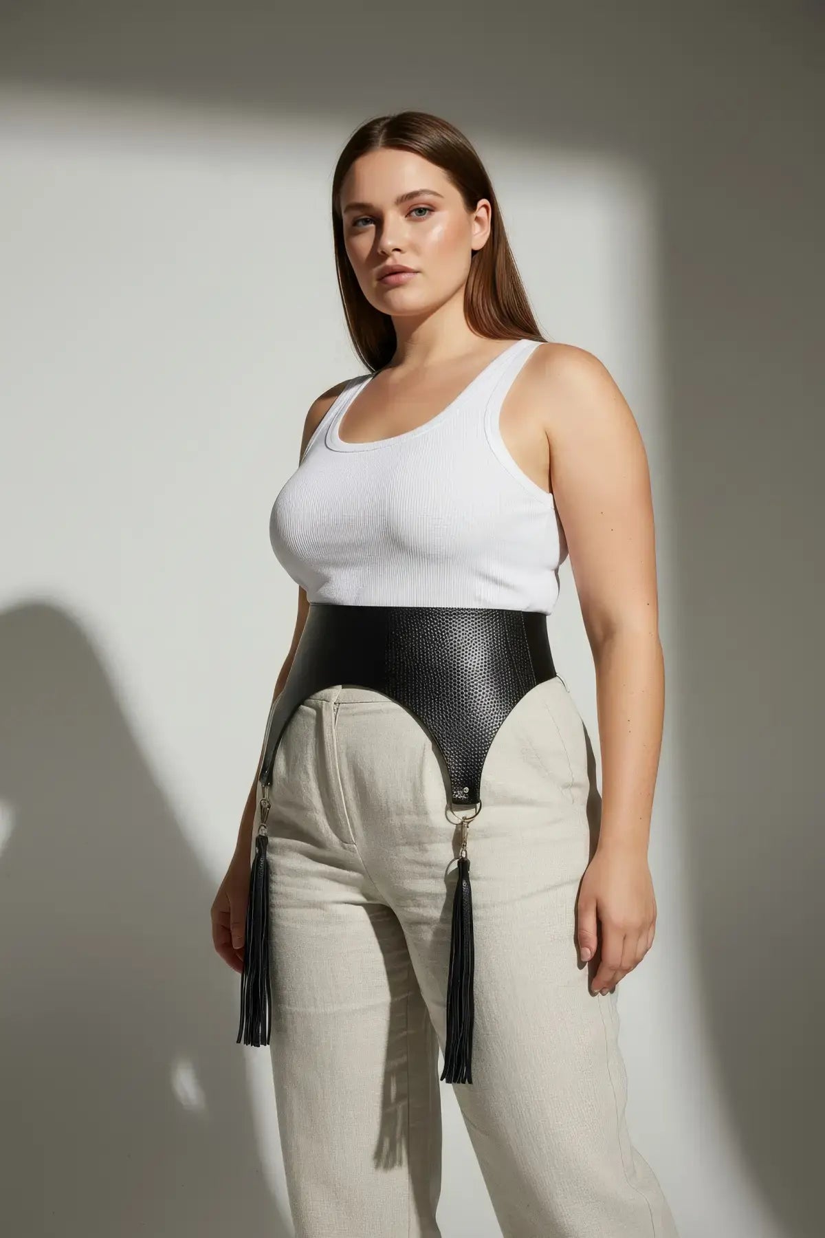 HarnessClub plus-size black pebbled wide corset waist belt with tassels, vegan leather, worn at the waist