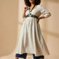 HarnessClub plus-size black vegan-leather corset harness with shoulder straps worn over a white dress
