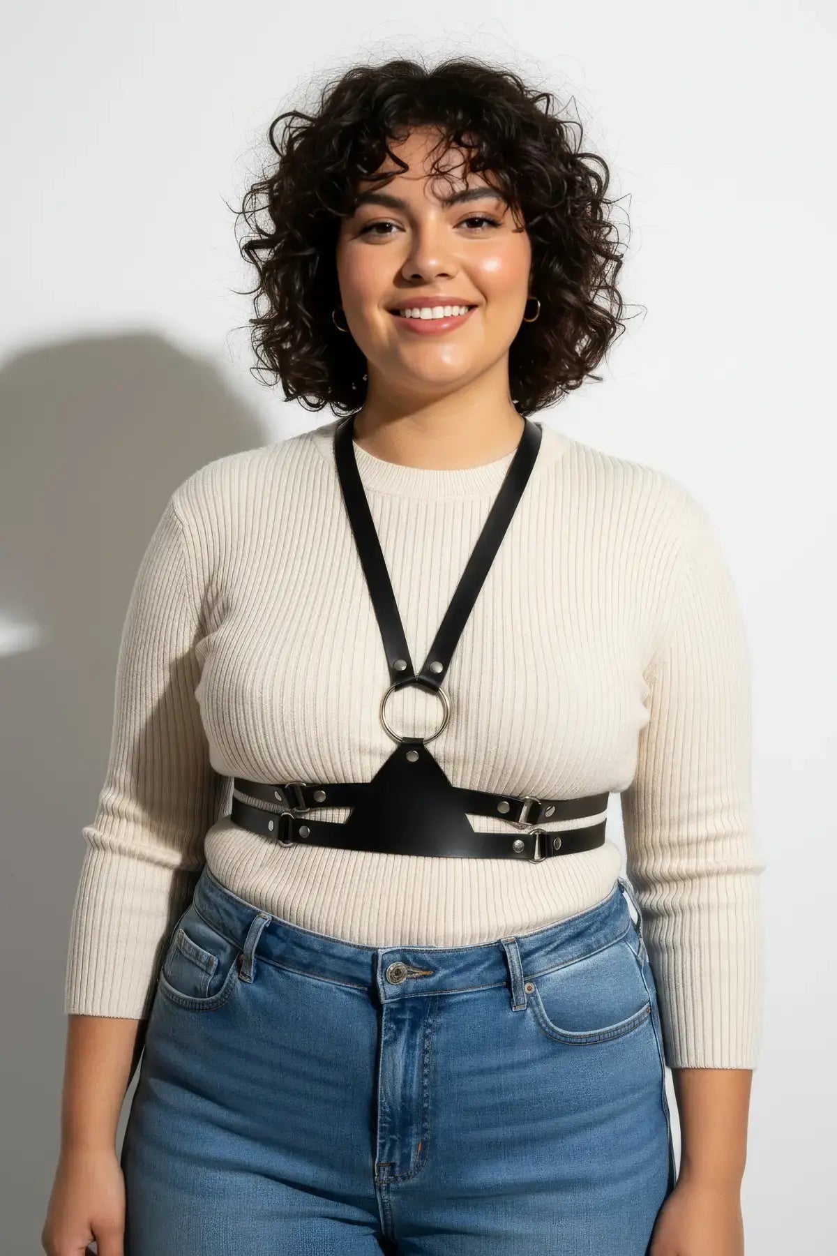 Plus-size black vegan-leather shoulder-strap corset harness with a central ring and slim V-neck straps.