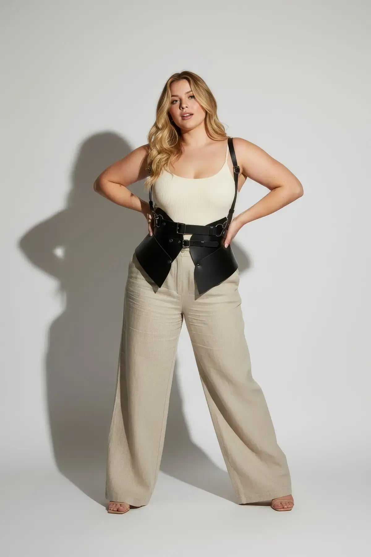 Plus-size black vegan leather shoulder strap harness vest with double buckles and peplum waist cincher
