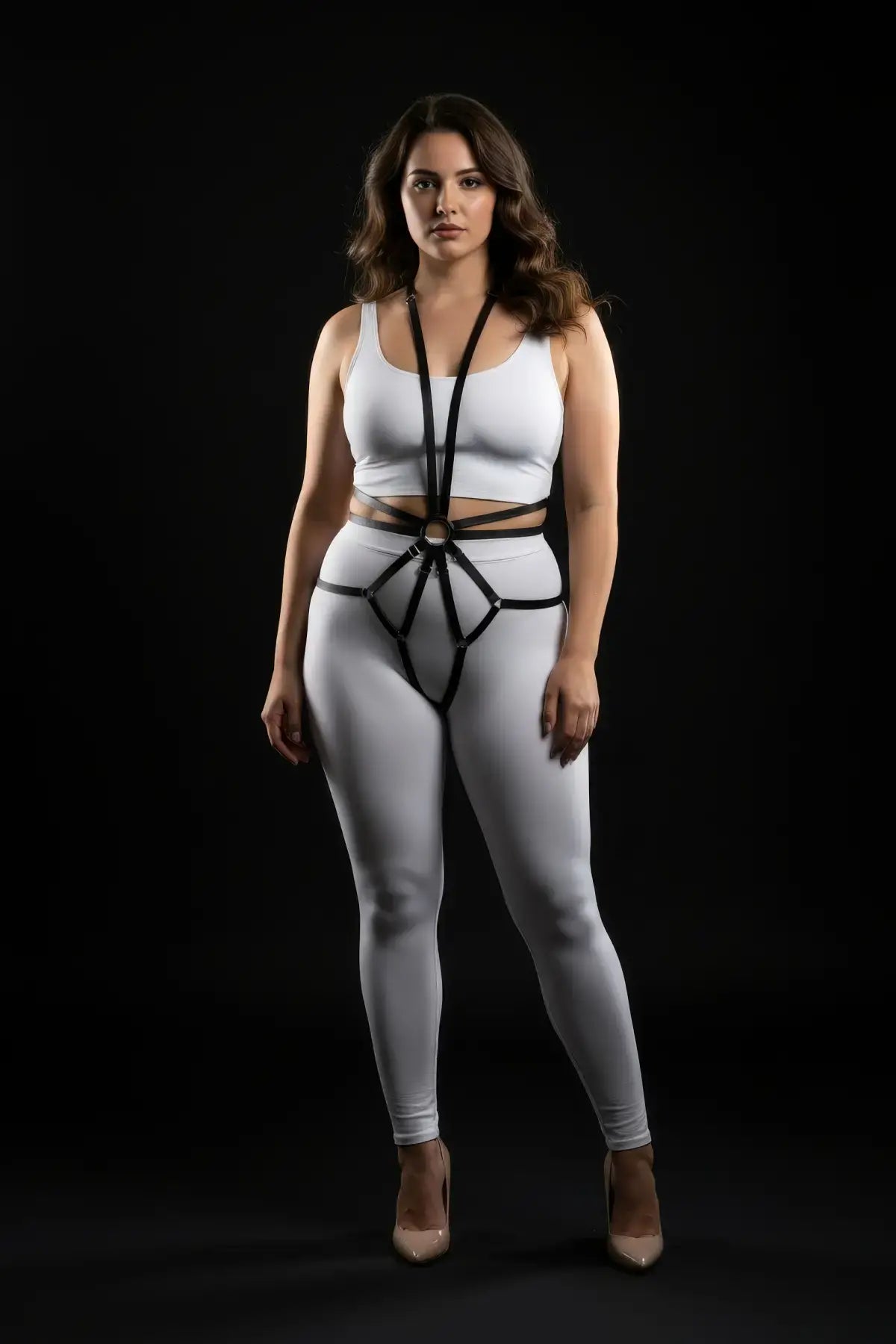 Plus size black starburst ring full body harness with vegan leather straps, worn over white activewear.