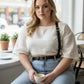 Plus-size black strappy leather belt worn as a body-accessory with shoulder strap by HarnessClub.
