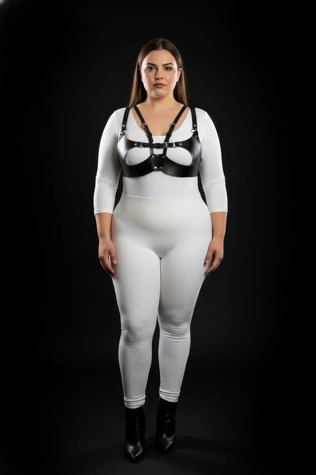 Plus-size black vegan leather chest harness worn over a white bodysuit on model