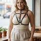 Plus-size black vegan leather cage chest harness with choker by HarnessClub worn by a model