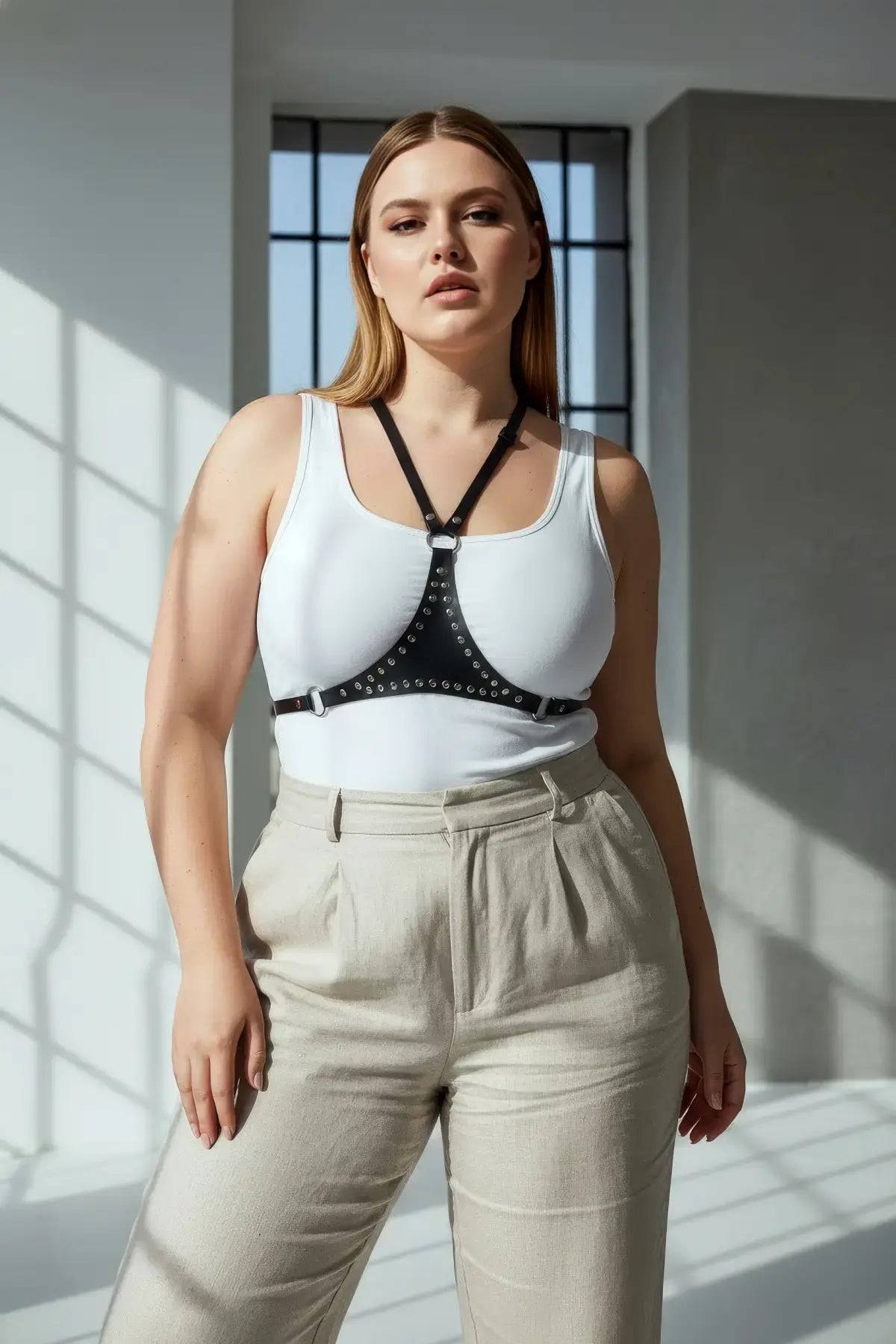 Plus-size black studded leather body harness with neck strap and metal studs