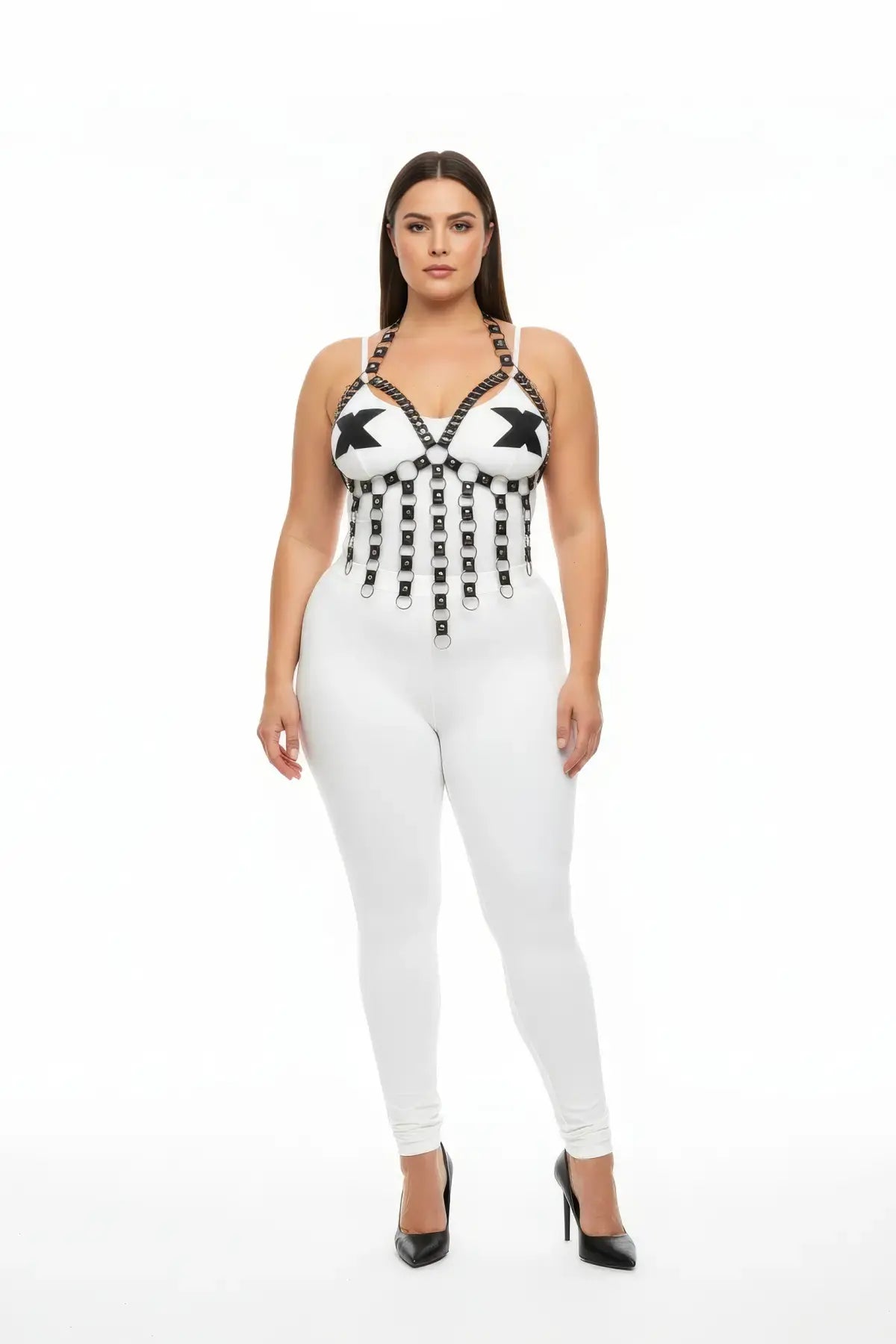 Plus-size black vegan leather studded V-frame chest harness with fringe and O-rings on white bodysuit