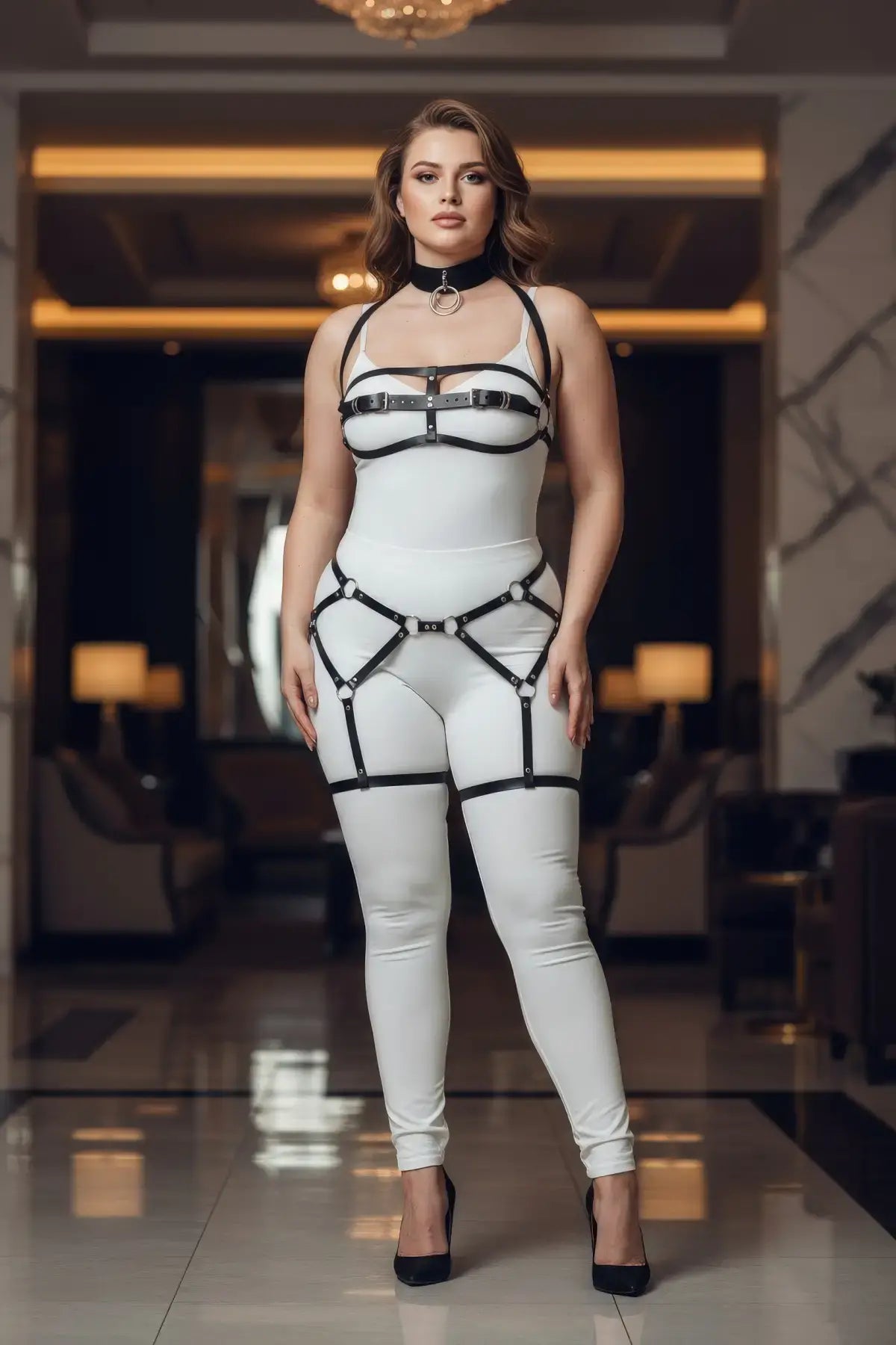 Plus-size black suspender garter harness set by HarnessClub with faux-leather straps on a white bodysuit.