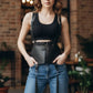Plus size black tassel suspender corset belt by HarnessClub, vegan leather harness worn over a black ribbed crop top