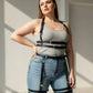Plus-size black faux-leather garter harness set for upper and lower body worn over a gray tank top