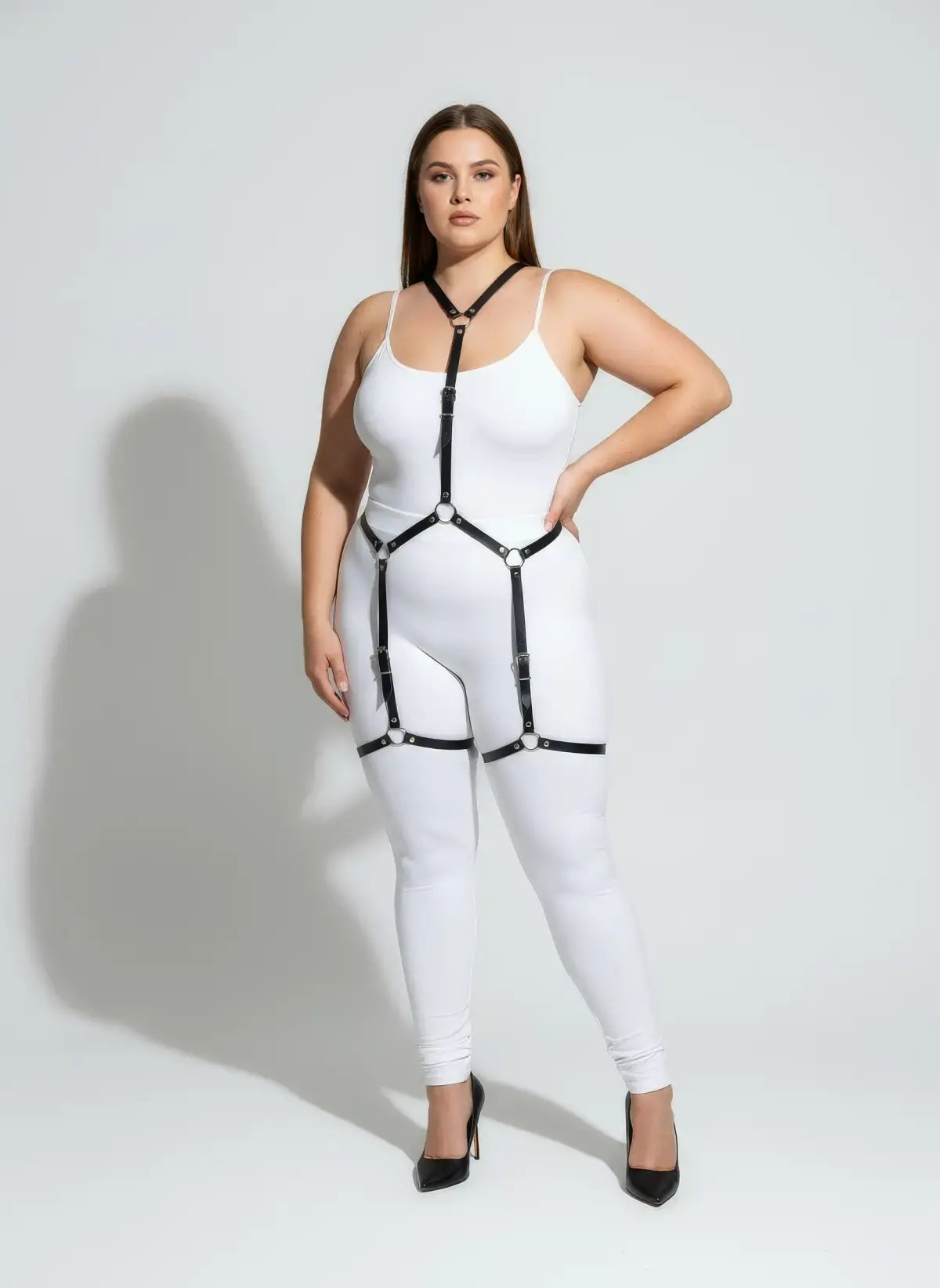 Plus-size black vegan leather full-body V-harness with hip garters and silver hardware