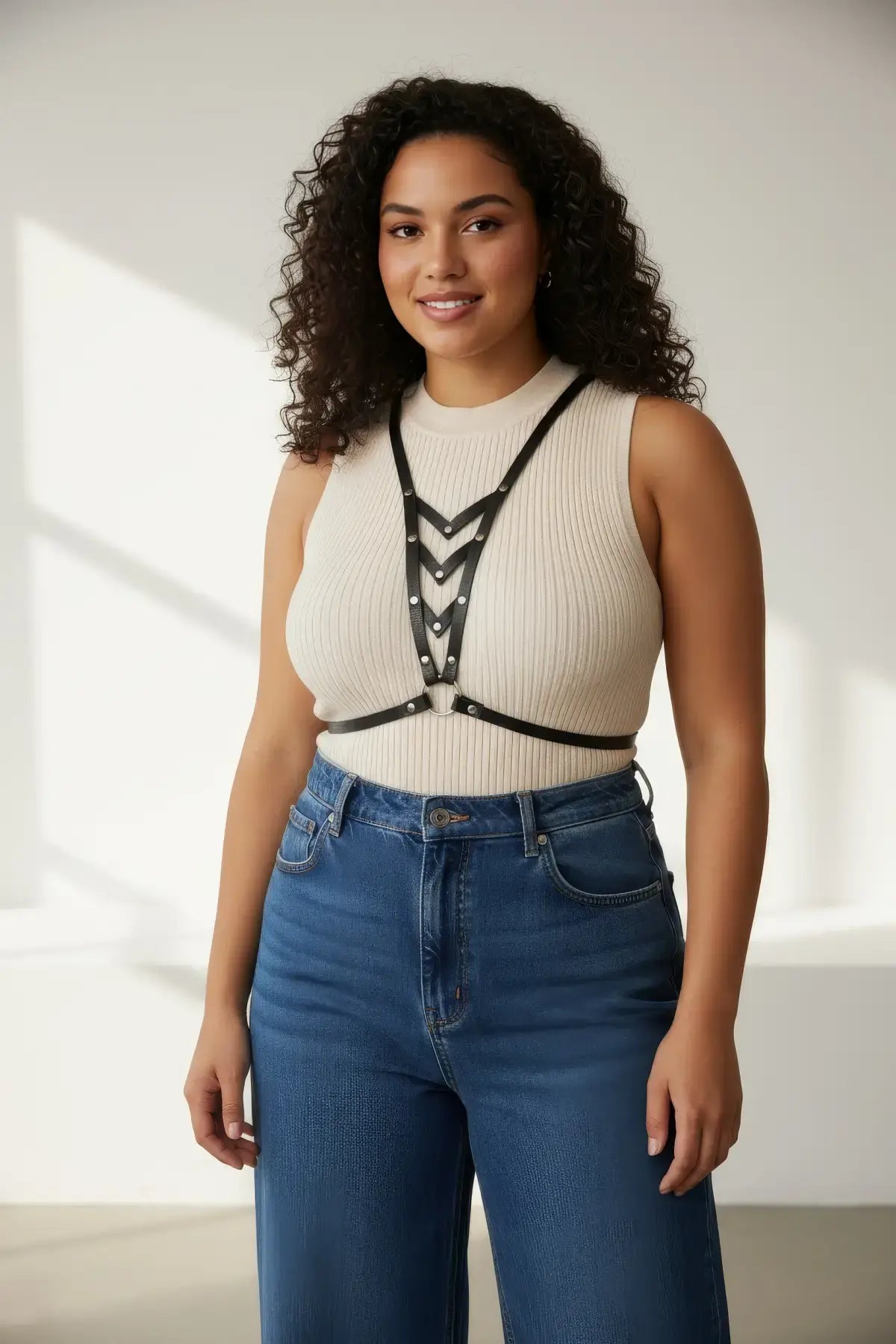 Plus Size Black V-Neck Chest Harness by HarnessClub in vegan leather worn over a beige sleeveless top.