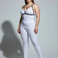 Plus-size black V-strap chest harness with keyhole detail worn over a white bodysuit by HarnessClub