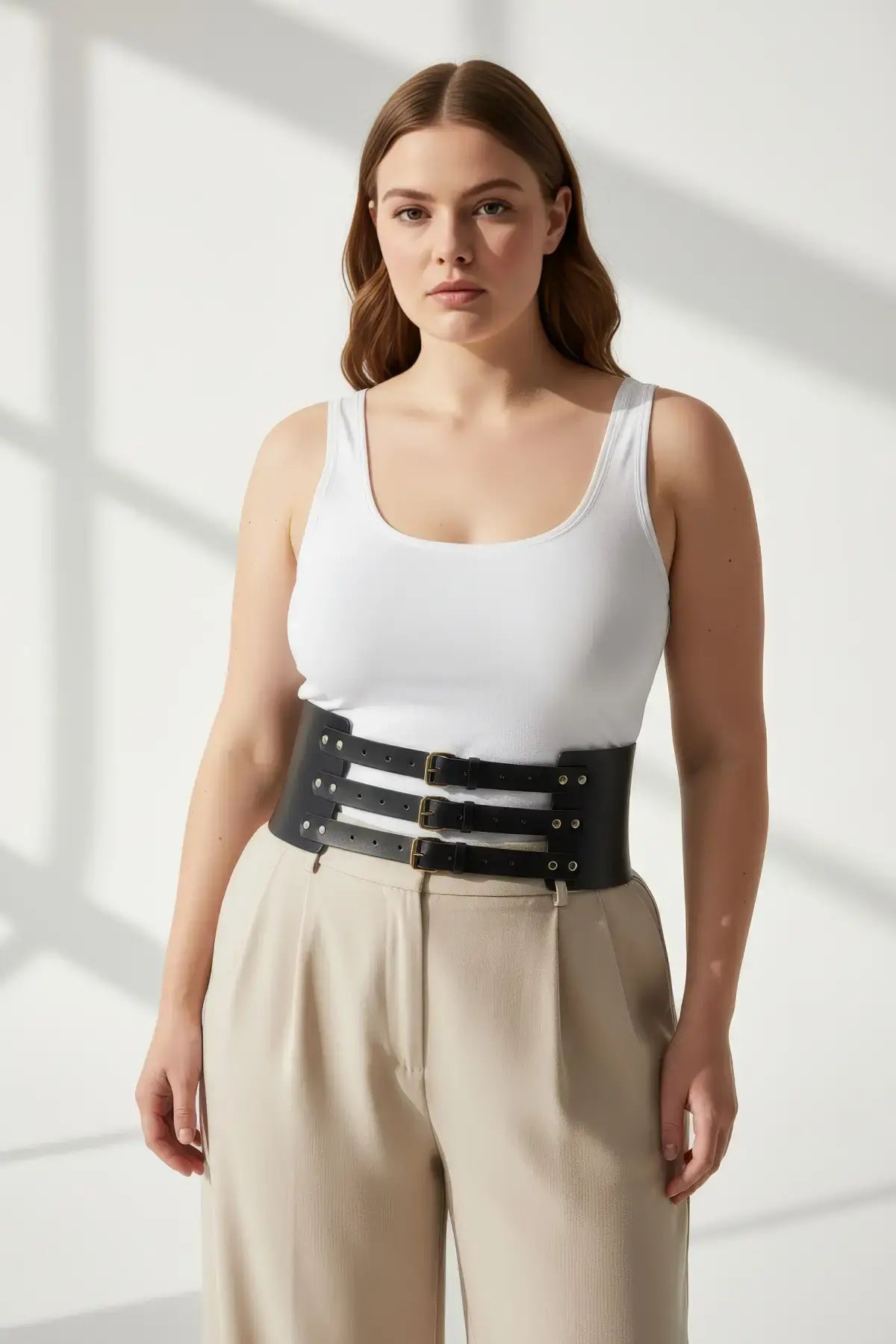 Plus-size black vegan-leather triple-buckle corset belt by HarnessClub worn at the waist