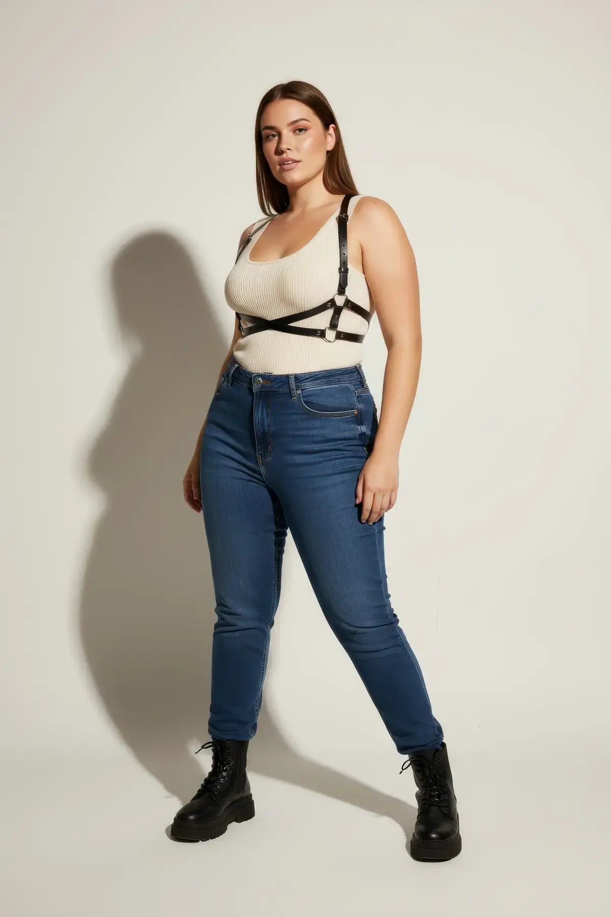 Plus Size Black X-Cross Shoulder Harness by HarnessClub in vegan leather worn over a cream ribbed tank.