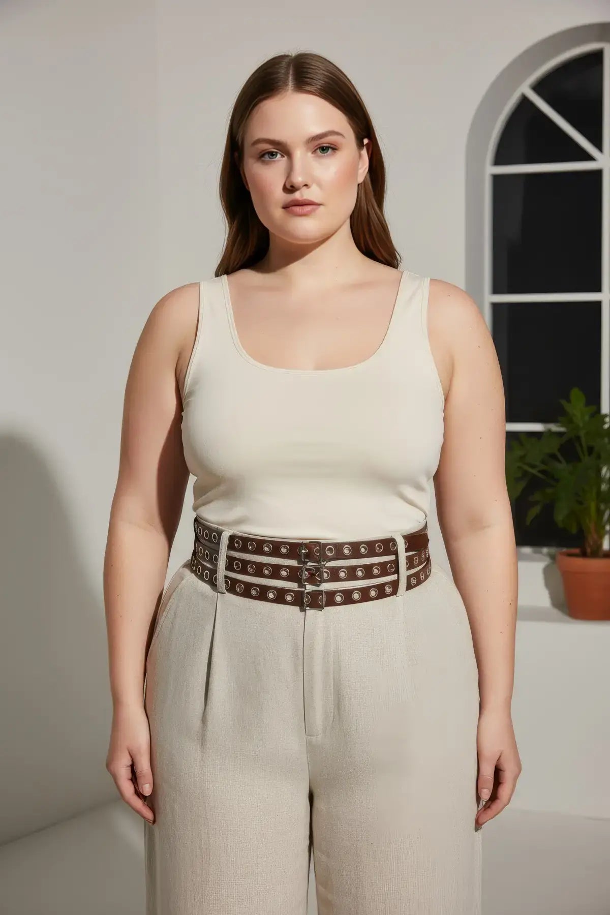 Plus-size brown vegan-leather belt with triple-row grommets and multiple buckles