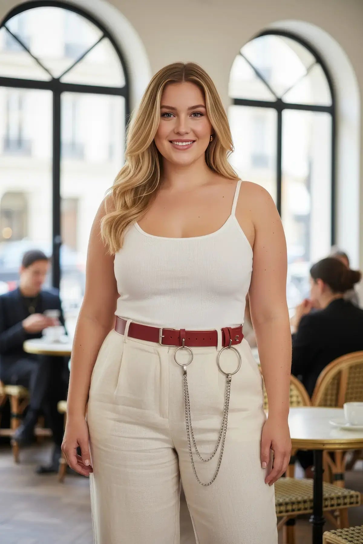 Plus-size burgundy vegan leather slim waist belt with O-rings and chains worn by a model