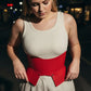 Plus Size Burgundy Wide Corset Belt by HarnessClub in vegan leather, worn over a cream sleeveless top.