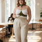 Plus-size chain-detail leather body harness by HarnessClub in olive green, worn over a white top.