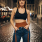 Plus Size Cognac Tassel High-Waist Hip Belt by HarnessClub, vegan leather harness worn over jeans.