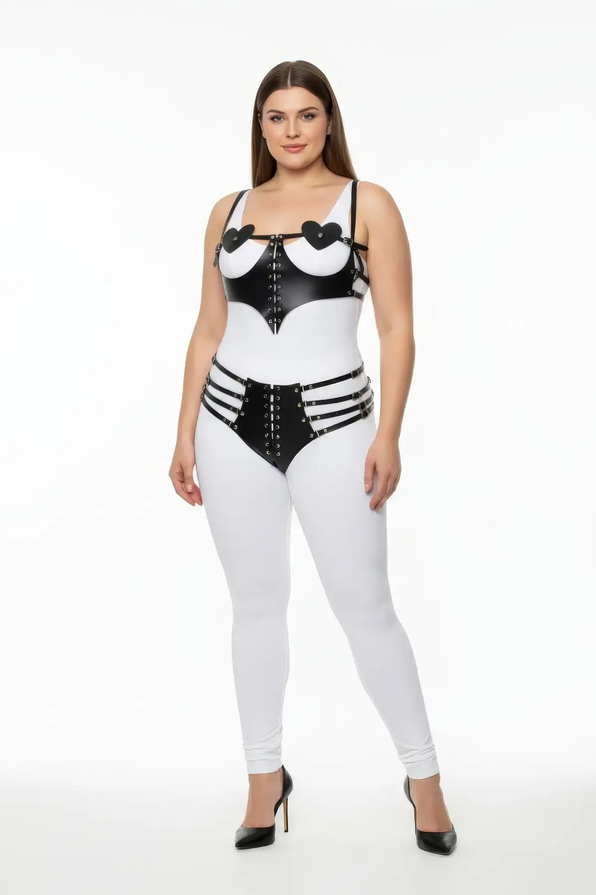 Plus-size white vegan-leather two-piece harness with black heart-detail cups and lace-up front, strappy high-rise shorts