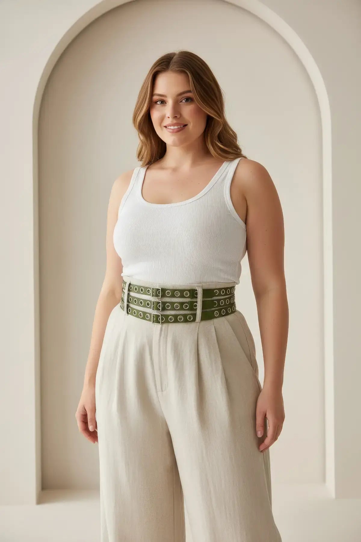 Plus-size khaki vegan-leather double-row grommet belt worn at the waist.