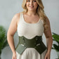 Plus-size khaki vegan-leather lace-up corset belt worn over a cream dress by HarnessClub