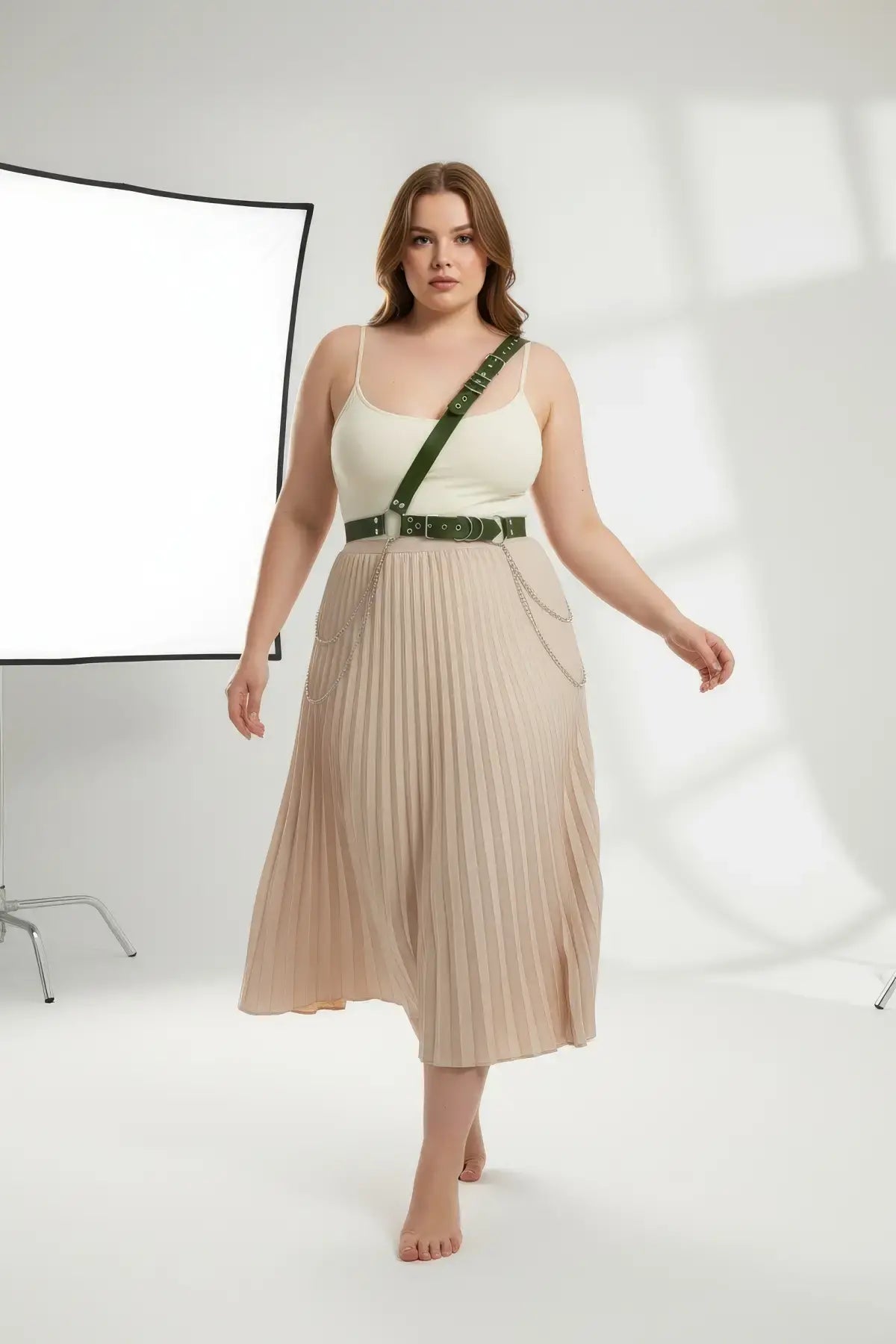 HarnessClub plus-size khaki leather body belt with chain detail worn diagonally across the torso.