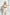 Plus-size khaki leather body harness worn over beige top