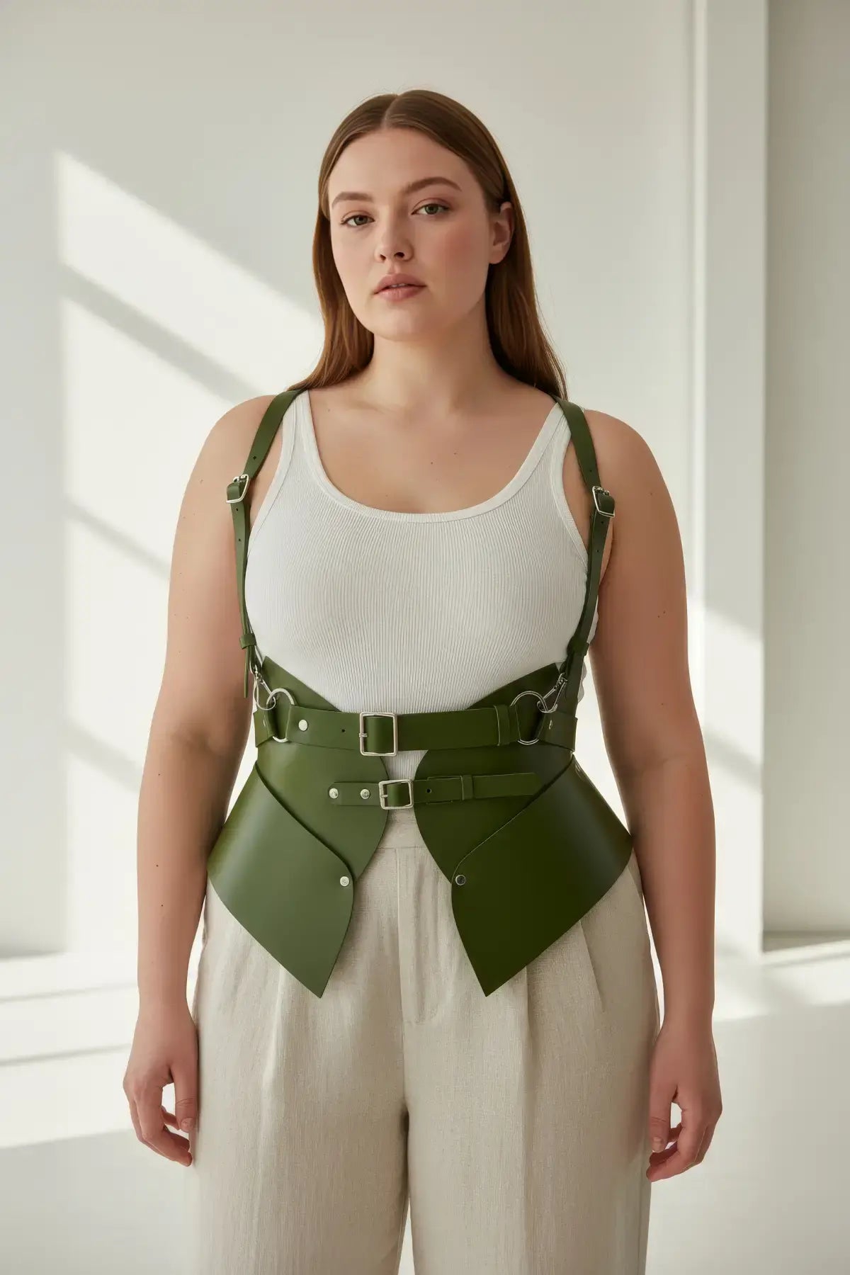Plus-size khaki HarnessClub vegan leather shoulder strap harness vest with peplum waist cinchers.