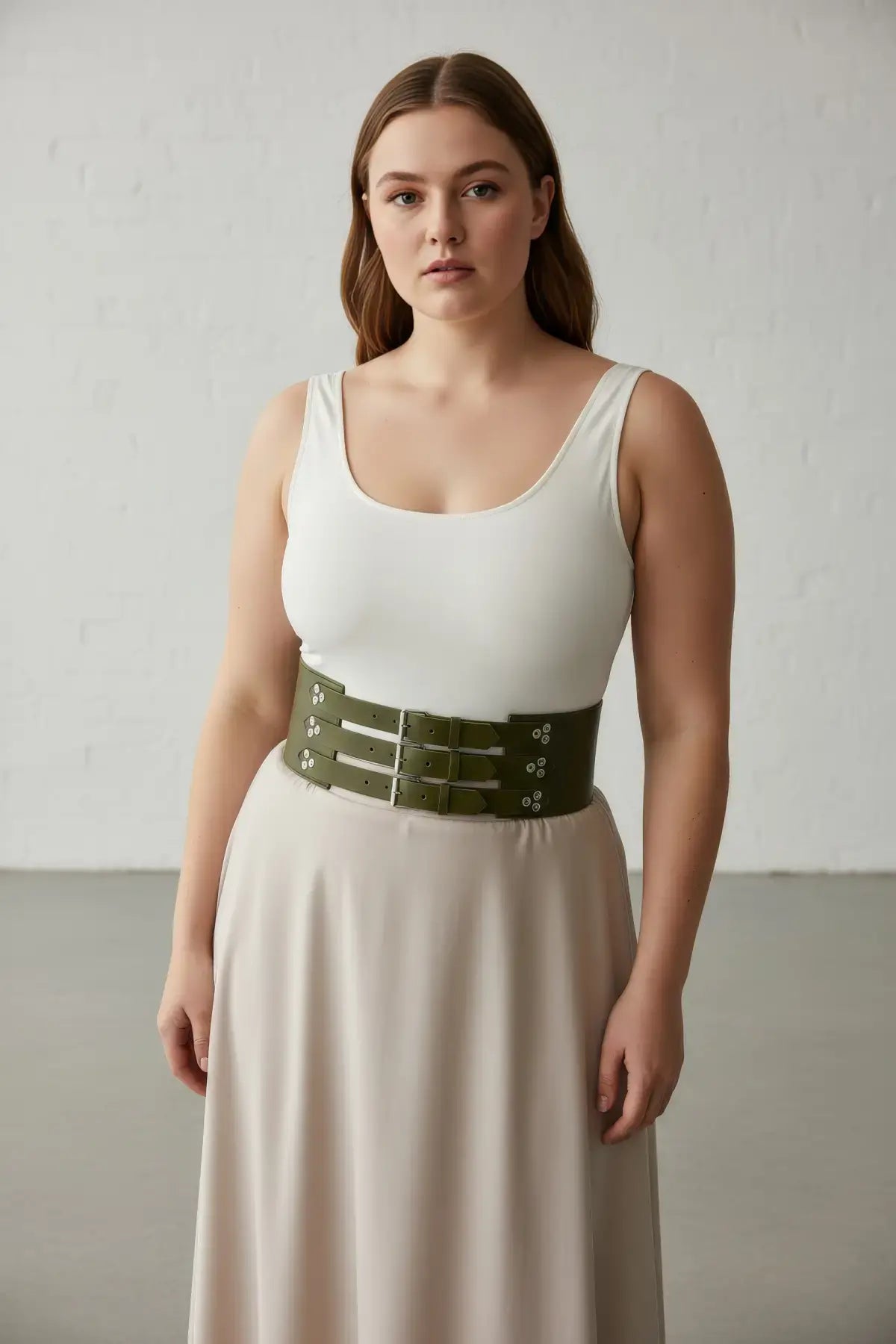 Plus Size khaki three-strap thick corset waist belt by HarnessClub worn over a white tank top.