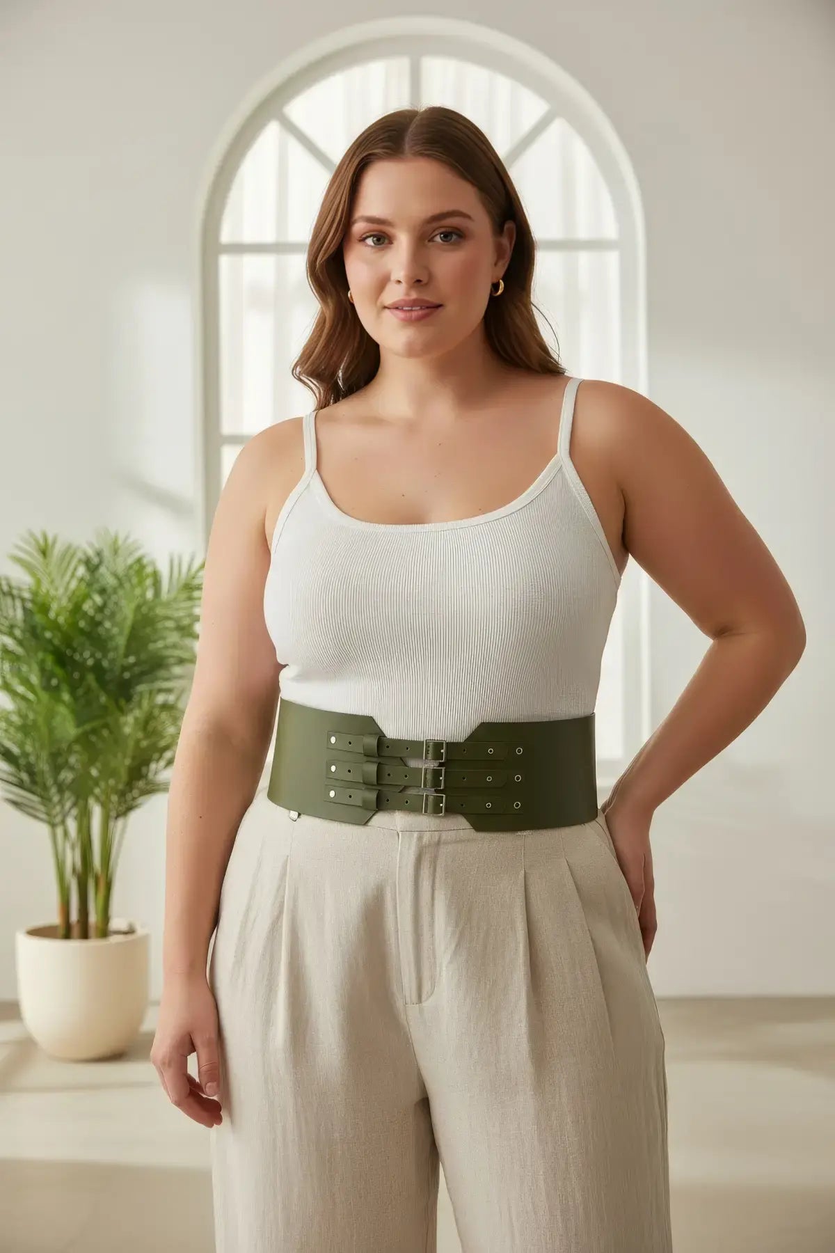 Plus size khaki triple-buckle corset belt in vegan leather worn around the waist