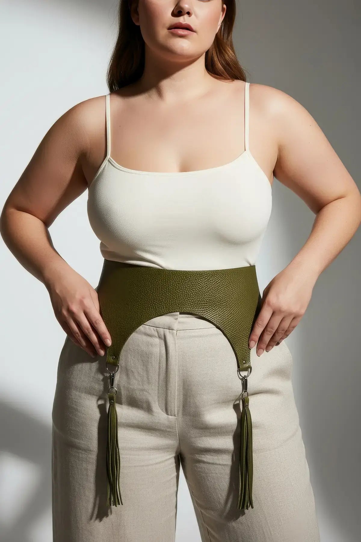 Plus-size khaki wide corset waist belt with tassels in olive vegan leather with pebbled texture.