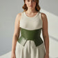 Plus-size khaki wide structured corset belt in vegan leather worn over a cream ribbed tank top
