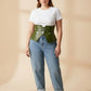 HarnessClub plus-size khaki vegan-leather corset belt, wide structured waist piece worn over a white tee and jeans.