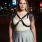 Plus-size black leather body harness with cross straps and shoulder fringe tassels, buckled front design
