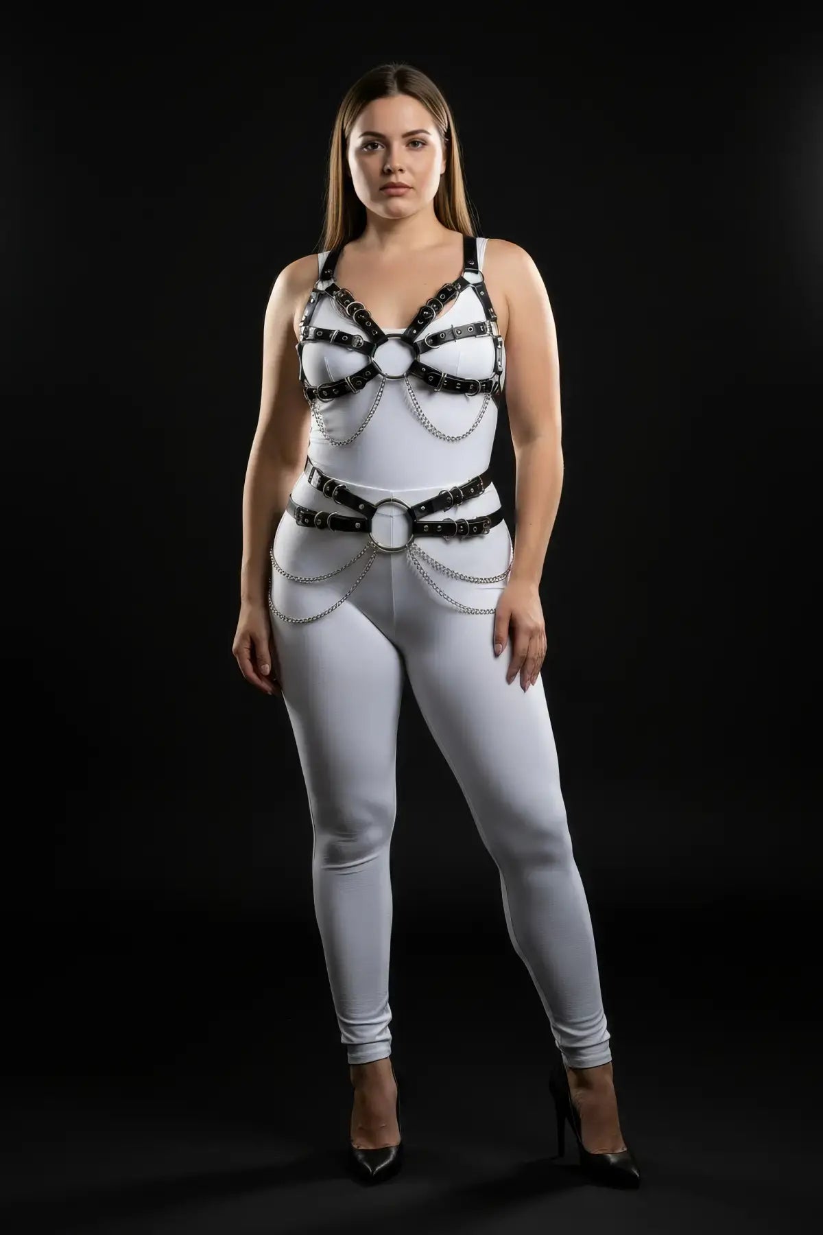 Plus-size vegan leather chest harness with chain-drape waist belt by HarnessClub on a white bodysuit