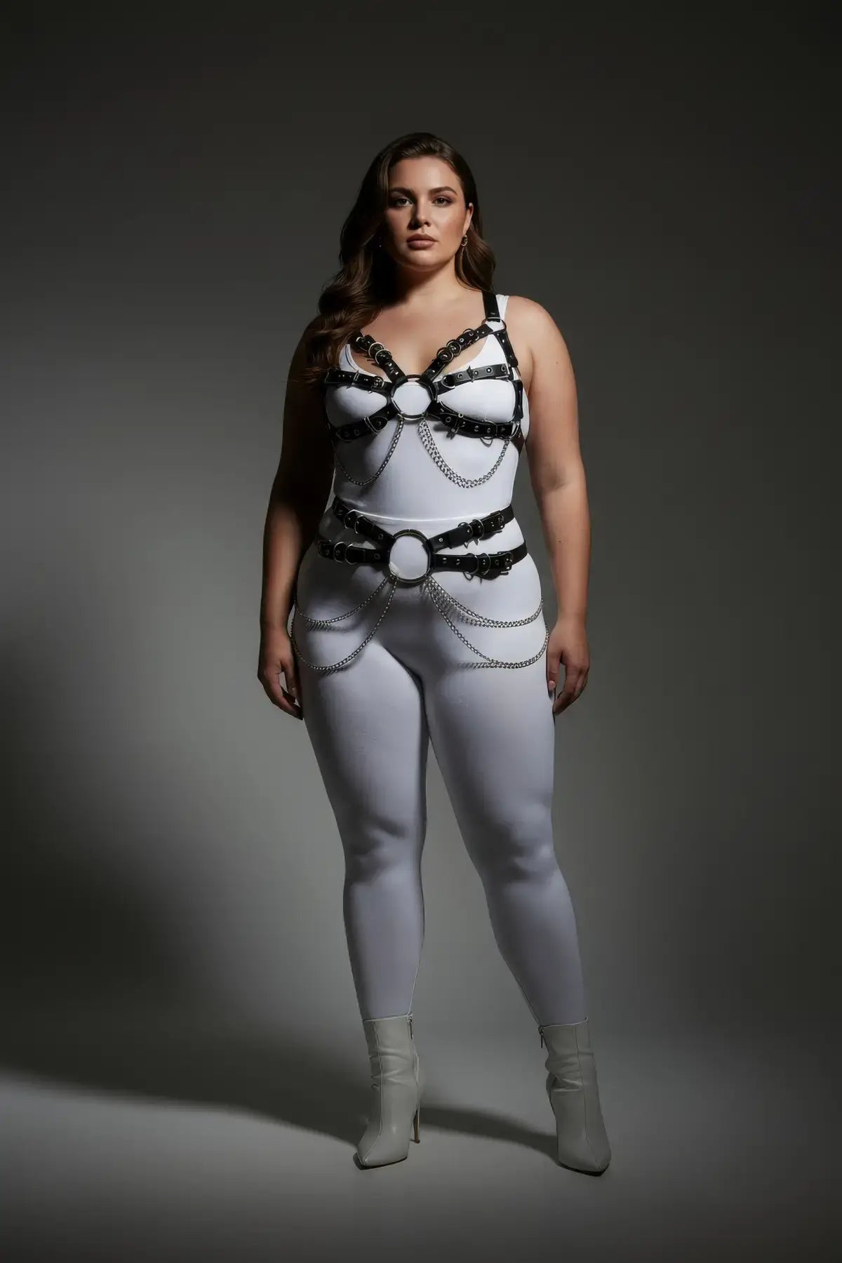 HarnessClub plus-size multi-buckle chest harness with chain-drape waist belt; vegan leather two-piece body accessory.