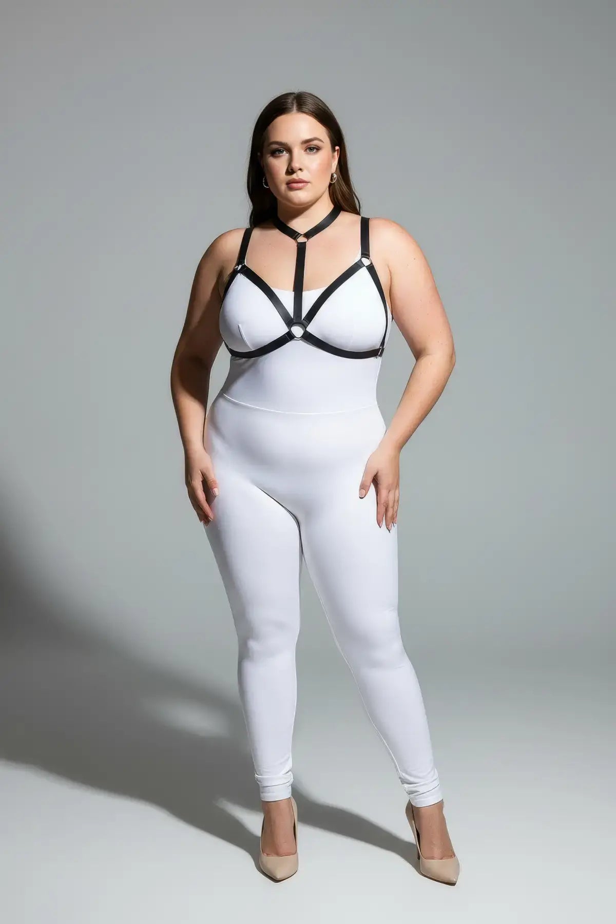 Plus-size elastic body harness set with black straps worn over a white bodysuit