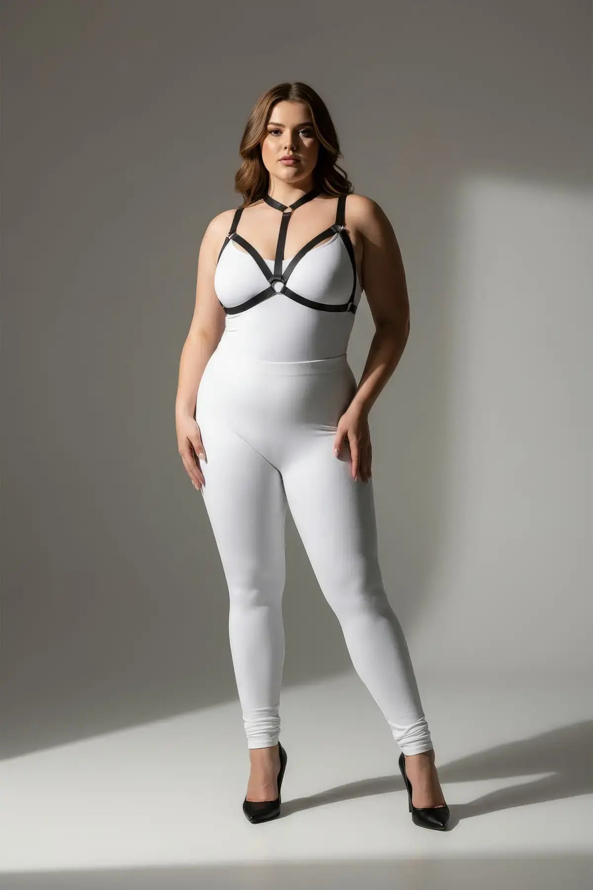 Plus-size black elastic body harness set worn over a white bodysuit with a choker-style collar and strappy design