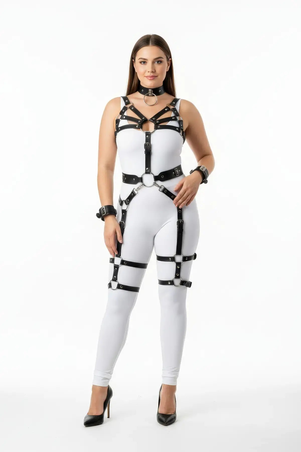 HarnessClub plus-size vegan leather body harness with wrist cuffs and garters worn over a white bodysuit