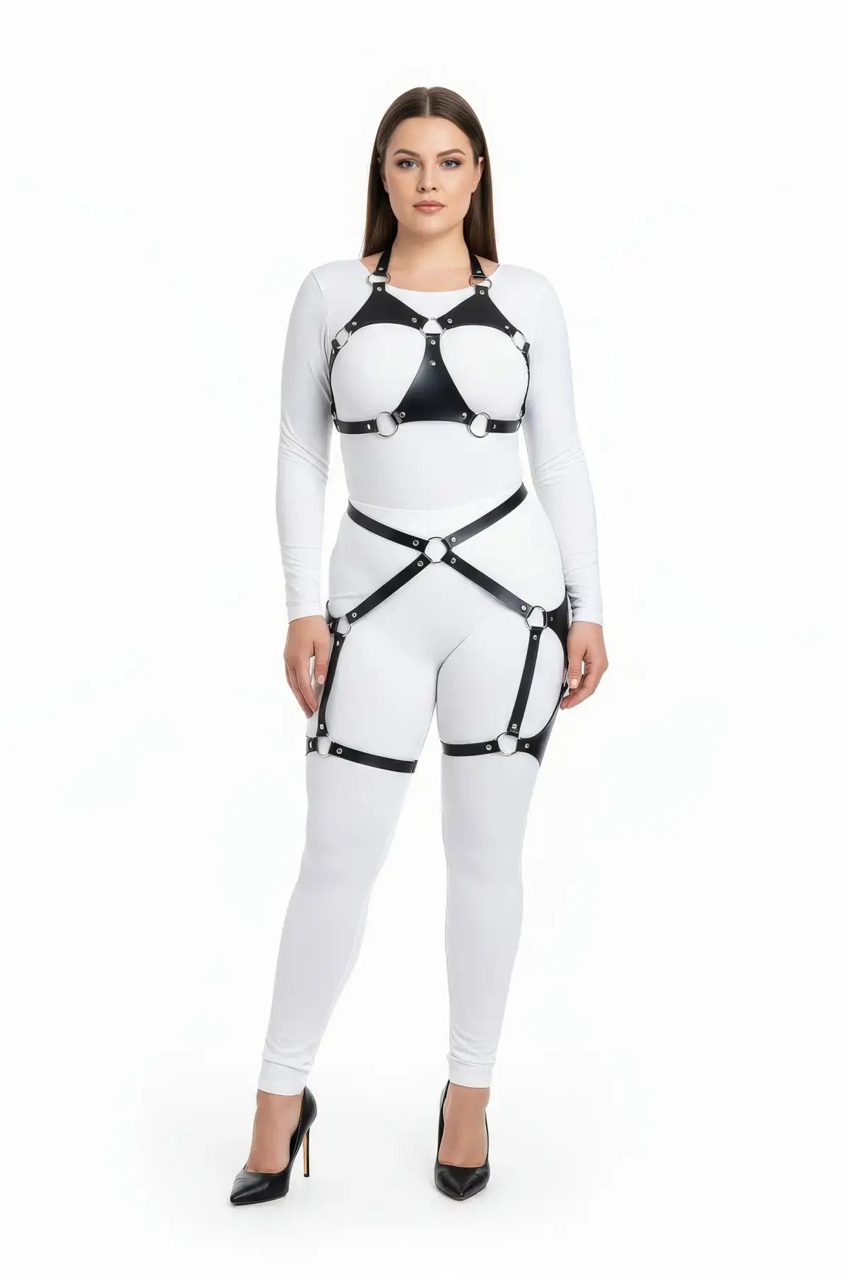 Plus-size O-ring bralette harness with crossover hip garter on white bodysuit, black vegan leather straps.