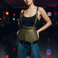 Plus size olive green tassel suspender corset belt worn over a black top; vegan leather harness.
