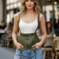 Plus size olive green vegan leather suspender corset belt with tassels worn over a white top