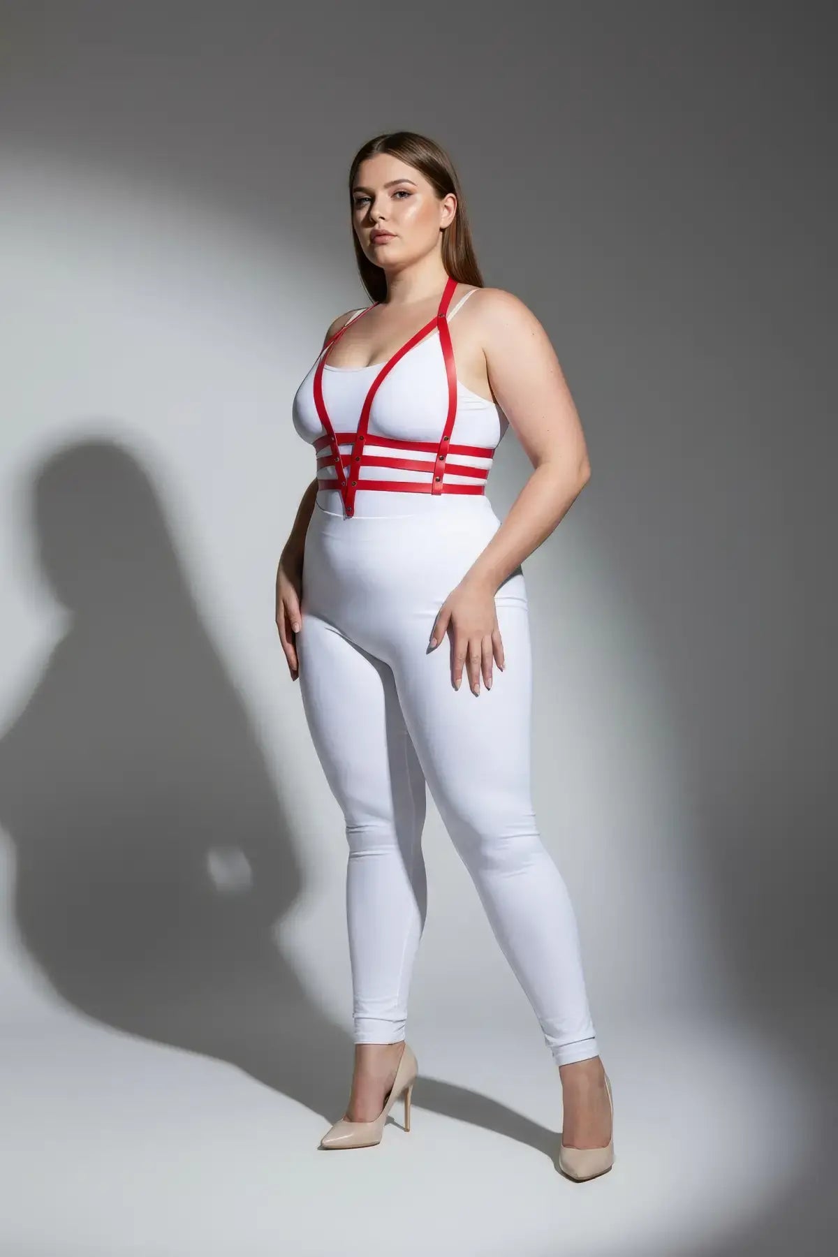 Plus Size Red Adjustable Faux Leather Body Harness Set by HarnessClub, modeled over a white bodysuit