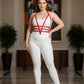 Plus-size red adjustable faux leather body harness set worn over a white bodysuit on a model