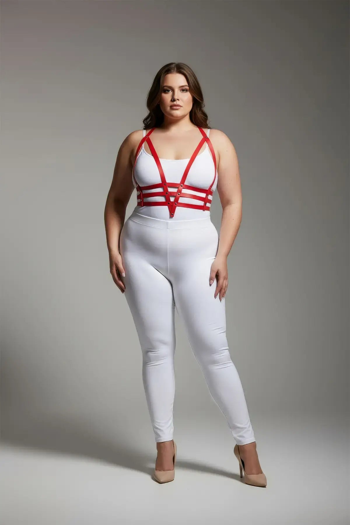 Plus-size red adjustable faux-leather body harness set with multiple straps around the torso worn over a white top