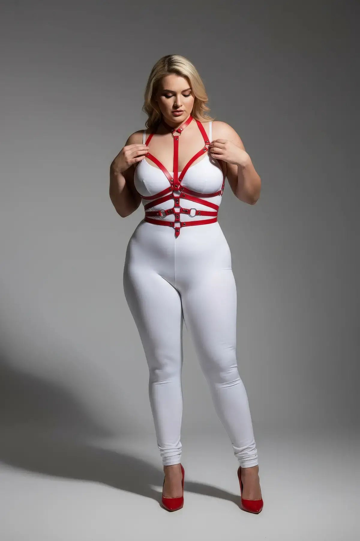 Plus-Size Red Adjustable Full-Body Faux Leather Harness worn over white bodysuit by HarnessClub