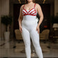 Plus-size red faux-leather harness bra over white bodice, model in white leggings and black heels.